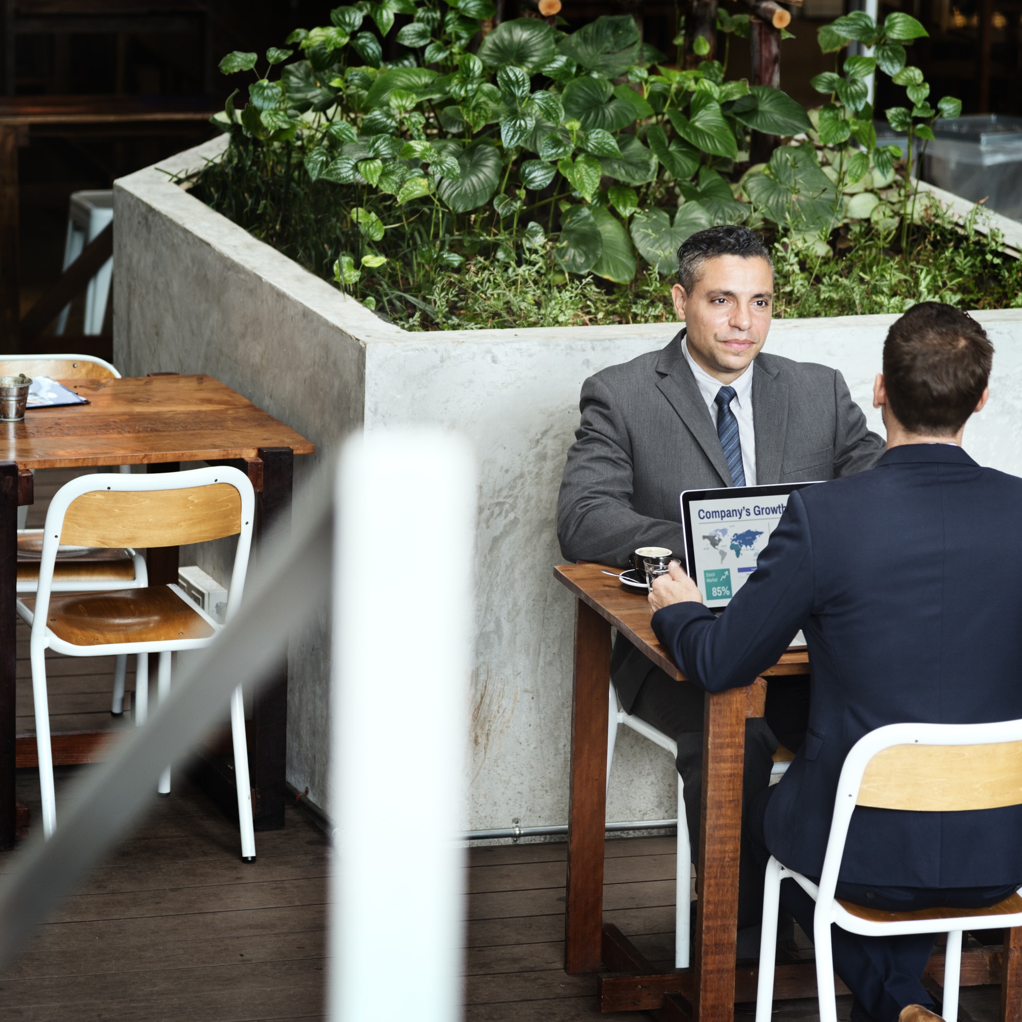 Two Businessmen Cafe Meeting Laptop Concept